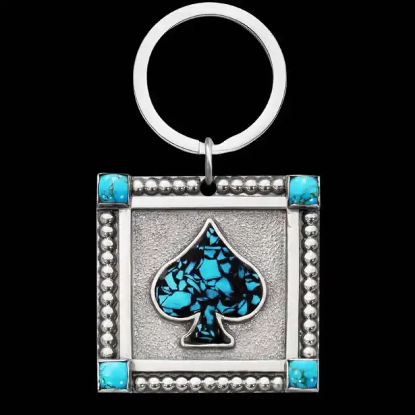 "Our Horizon Custom Keychain is about to become Molly's favorite! Handcrafted on a German Silver base featuring four simulated turquoise stones in each corner, a double border edge, and an ace figure with our signature crushed stone.

Size: 1.78” x